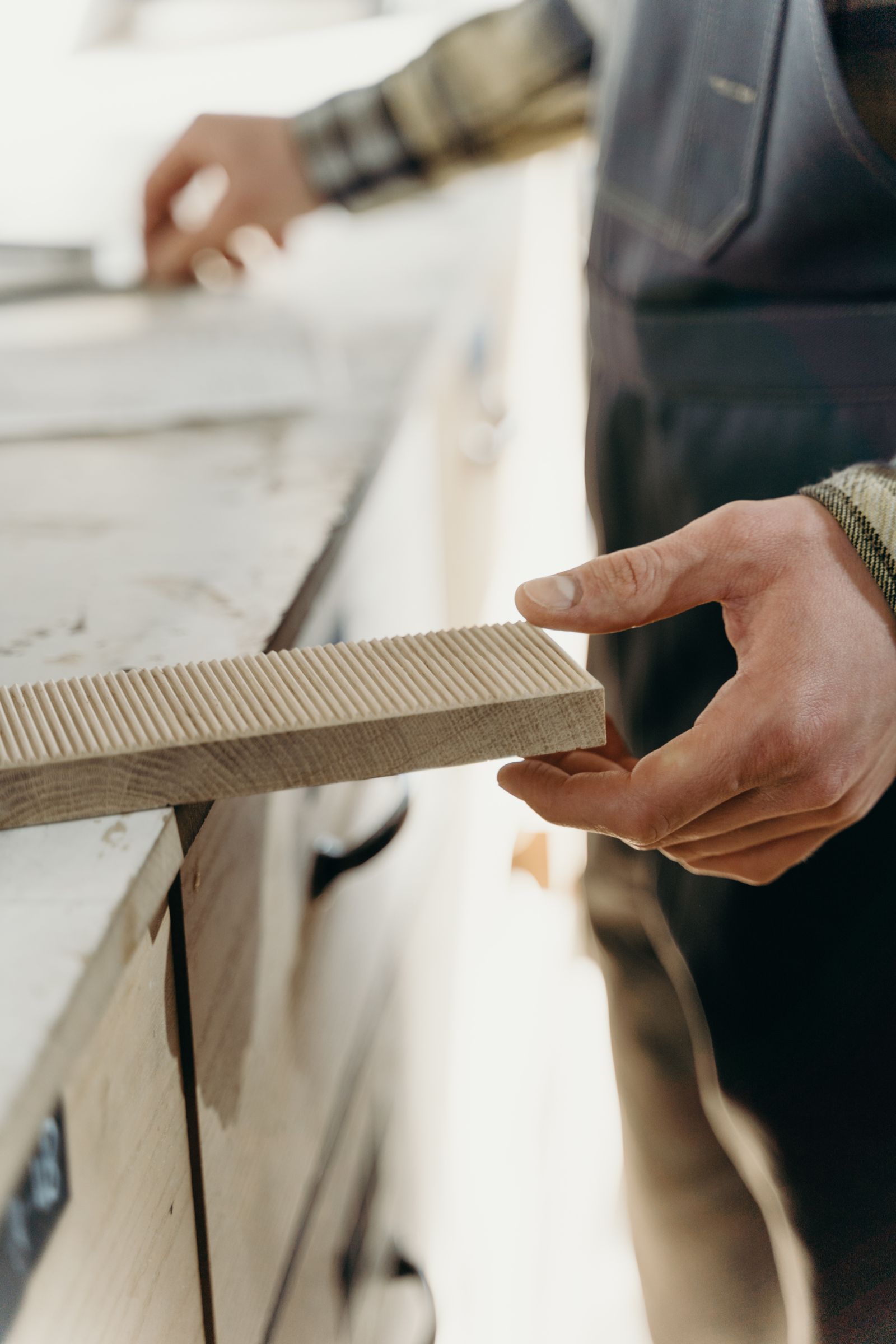 Carpenter checking a wood component in a workshop